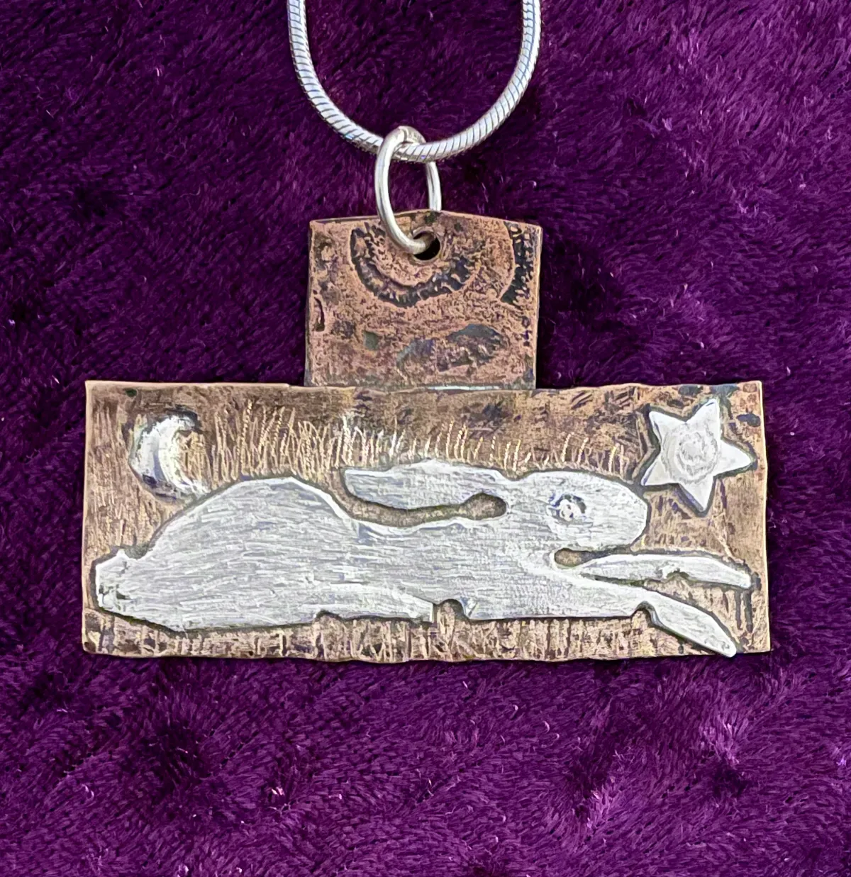 Silver hare on copper pendant