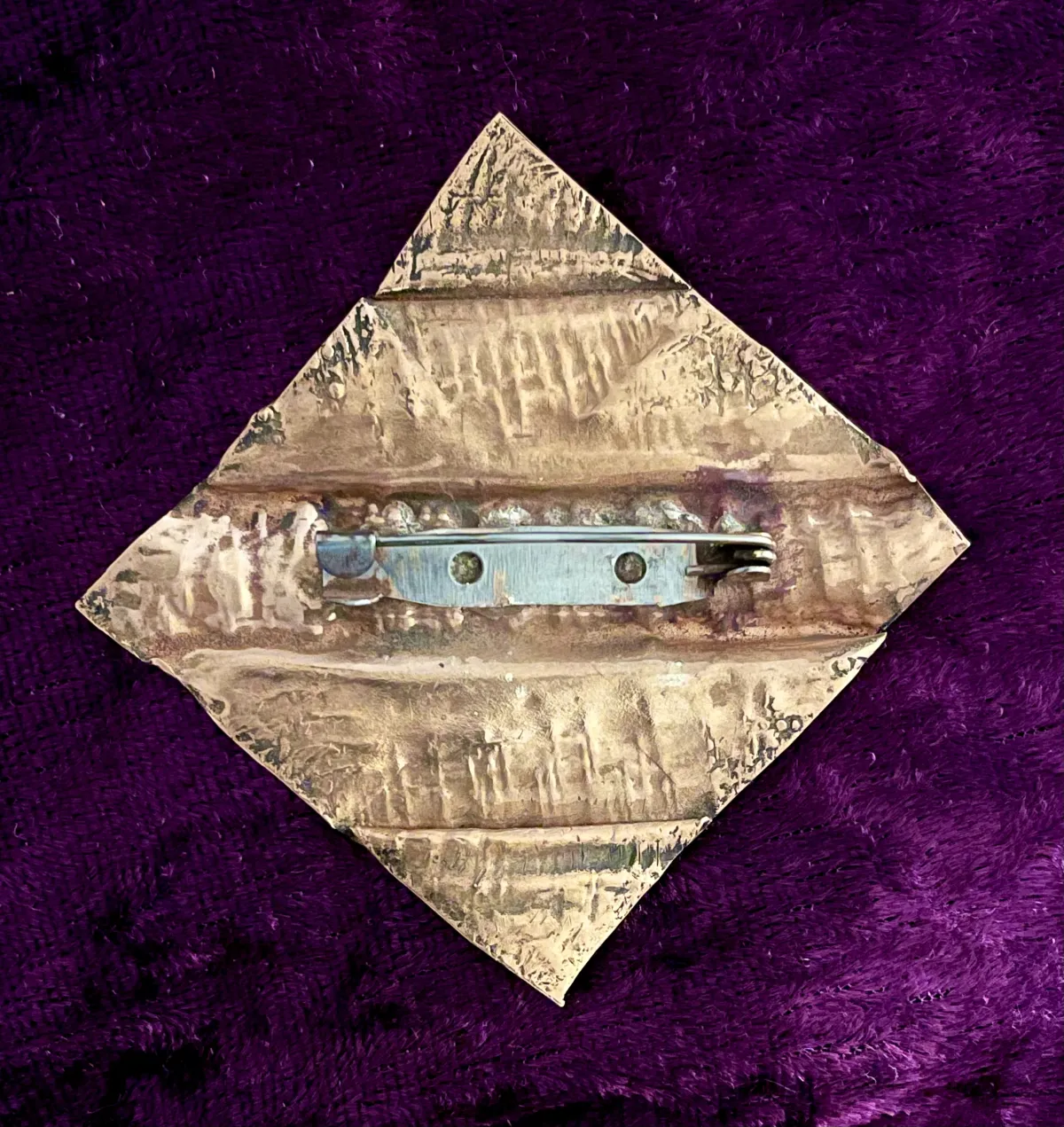 Hammered copper brooch