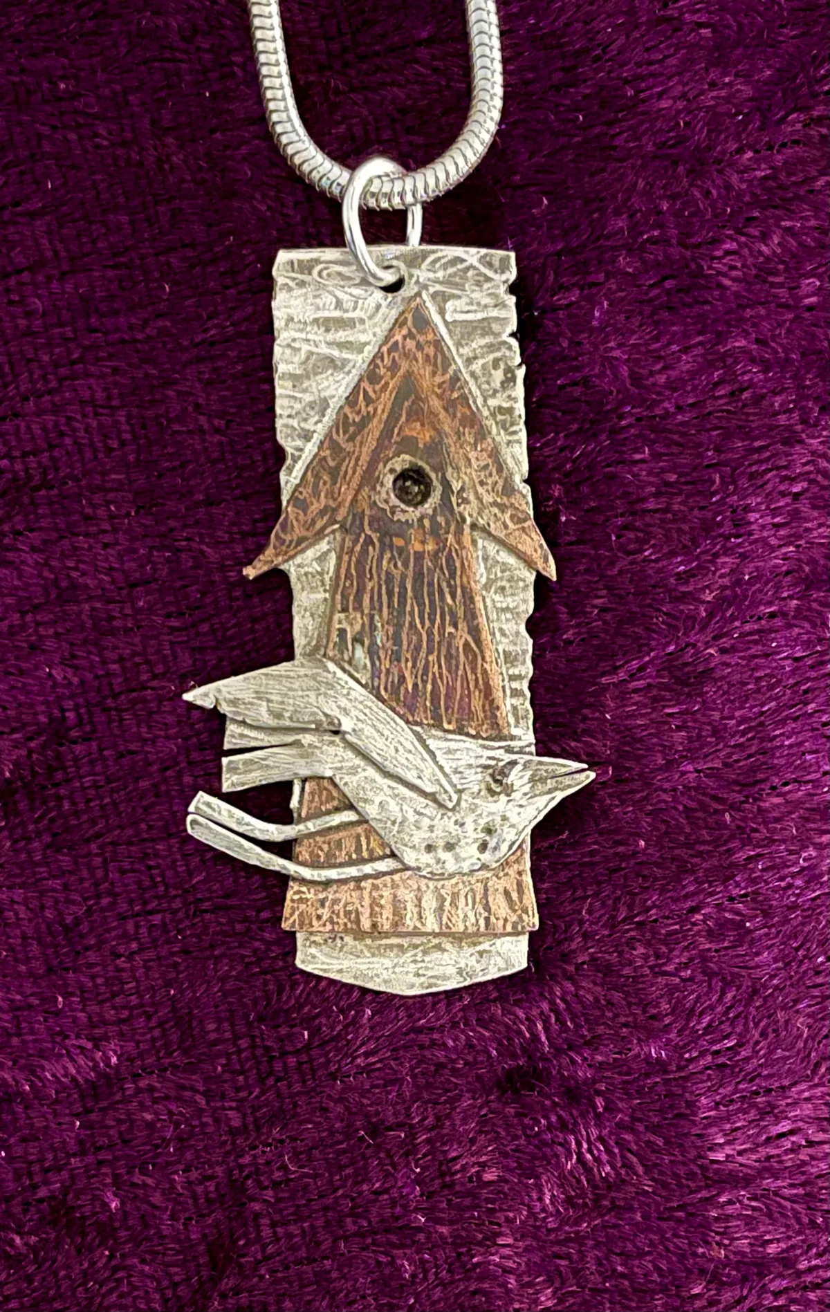 Silver bird and copper pendant