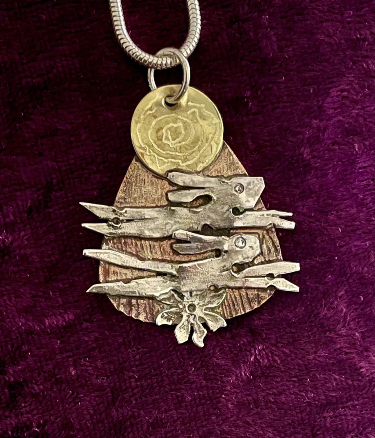 Pair of silver hares on copper