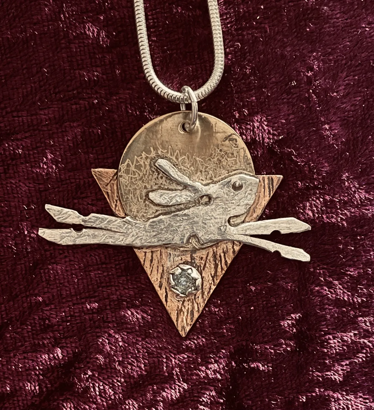 Running hare in silver pendant