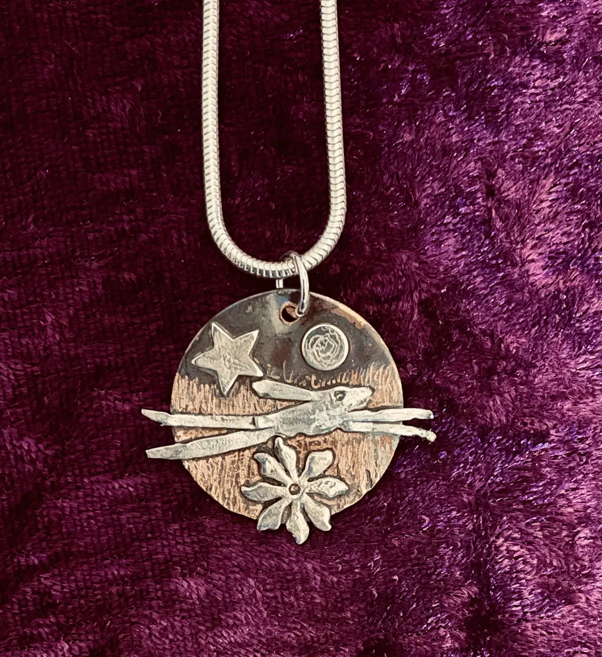 Silver hare on copper pendant