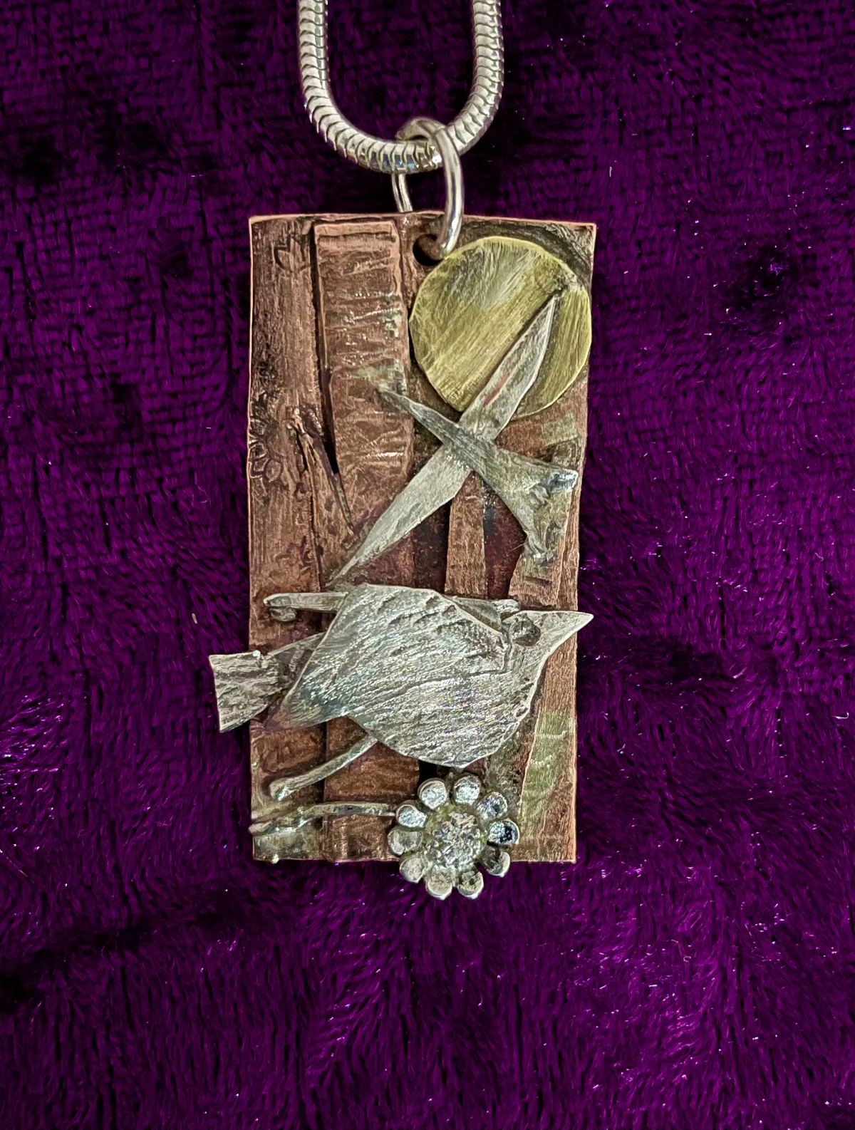 Silver birds on copper pendant