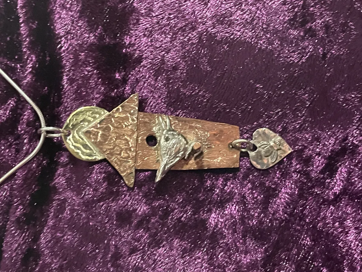 Silver bird on copper birdhouse