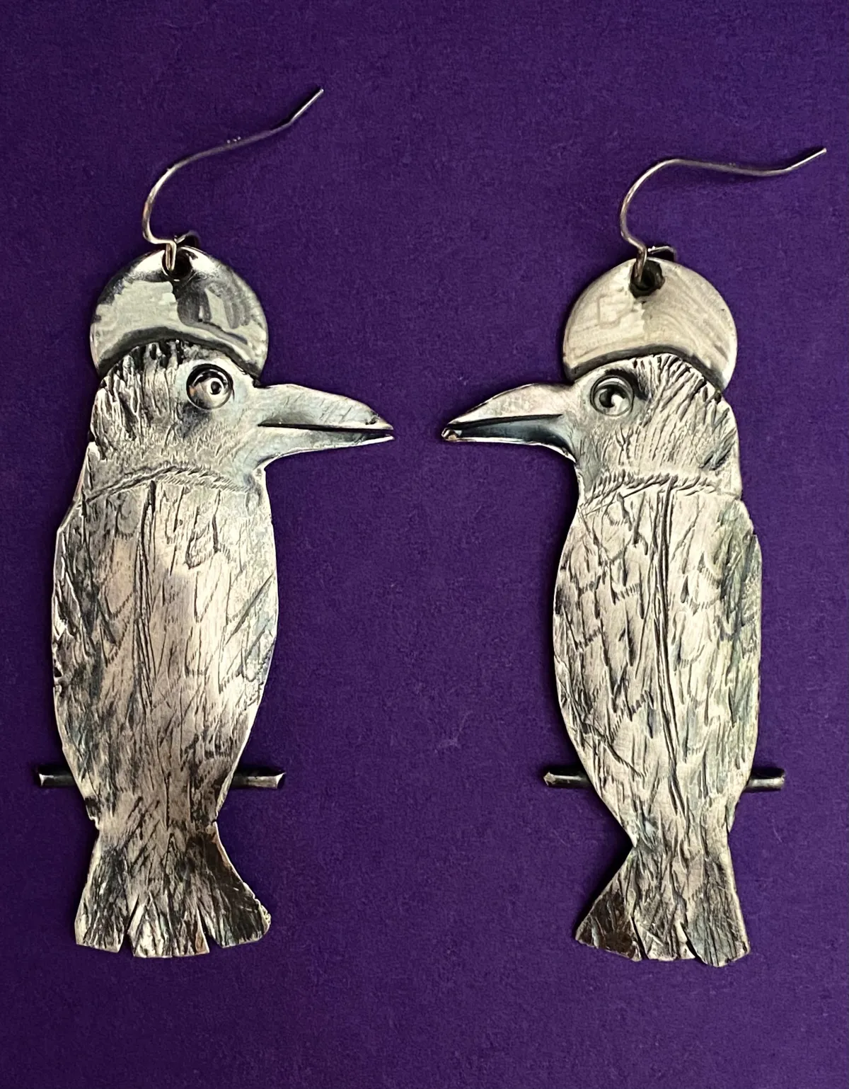 Silver Raven earrings.