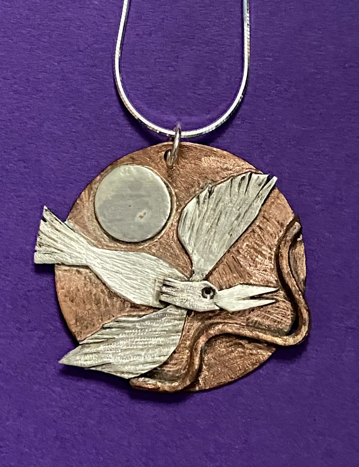 Silver swooping bird